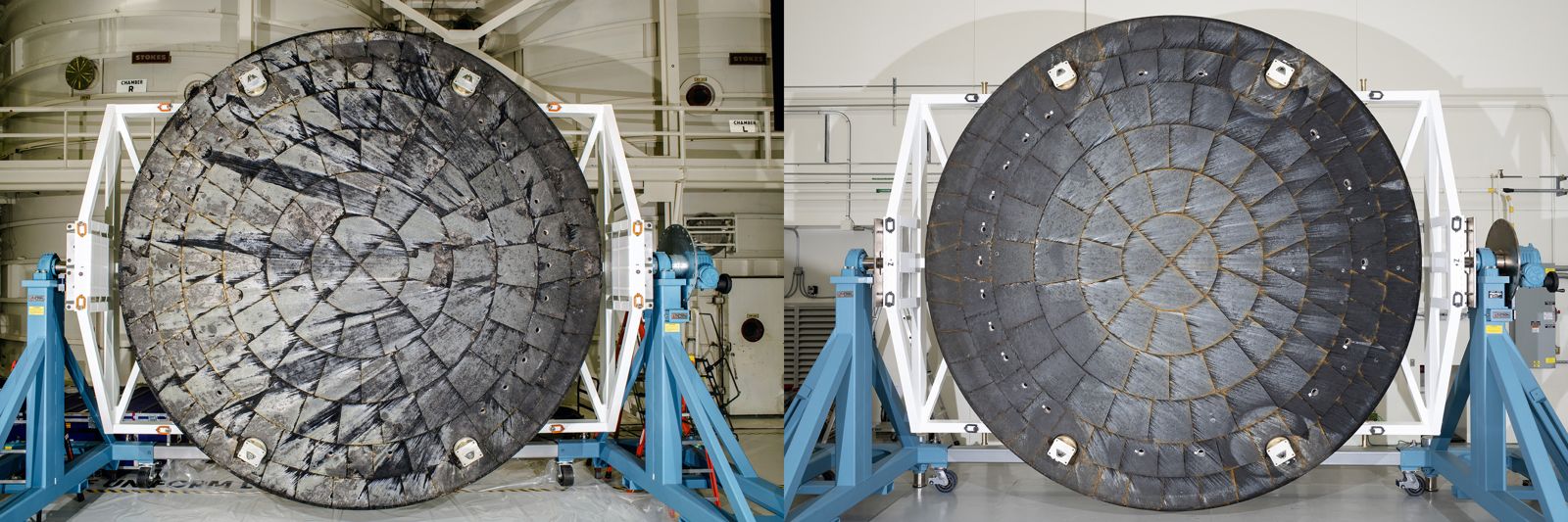 Two round, dark Orion heat shields side by side on blue stands, the left one heavily cracked and pitted, the right one much smoother