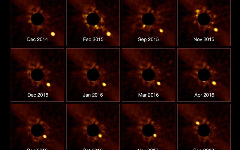 SPHERE time-lapse frames of exoplanet Beta Pictoris b orbiting its star, with the star blocked by a coronagraph