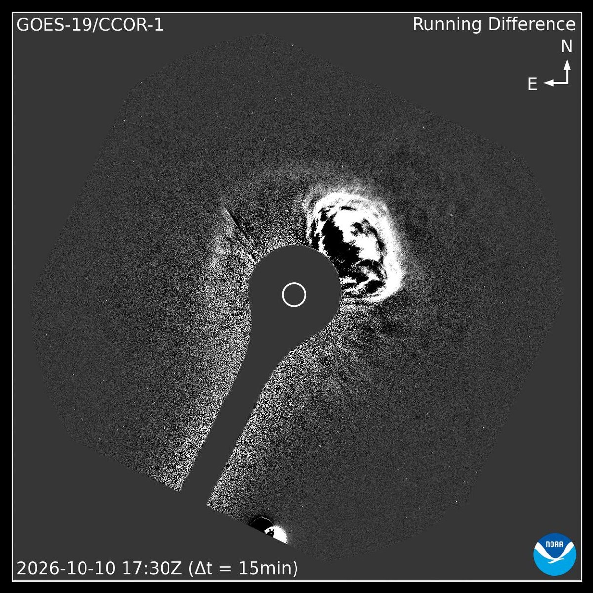 Black-and-white coronagraph difference image with the Sun blocked out by a central disk, showing a bright expanding cloud to the upper right (northwest), GOES-19 CCOR-1, Oct. 10, 2026, 17:30 UTC