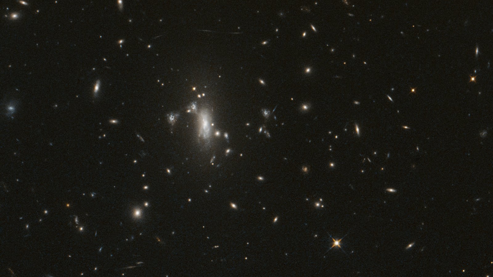Hubble view of galaxy cluster MACS J0417 in Eridanus: bright galaxies near the center and faint stretched arcs from gravitational lensing