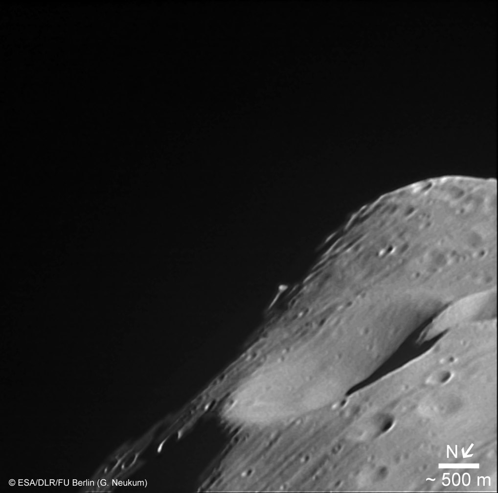 Black-and-white close-up of Phobos’s grey, cratered surface, taken by Mars Express