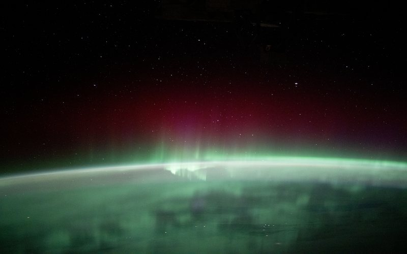 Green and red aurora borealis over Earth’s limb, photographed from the International Space Station — NASA iss072e159172