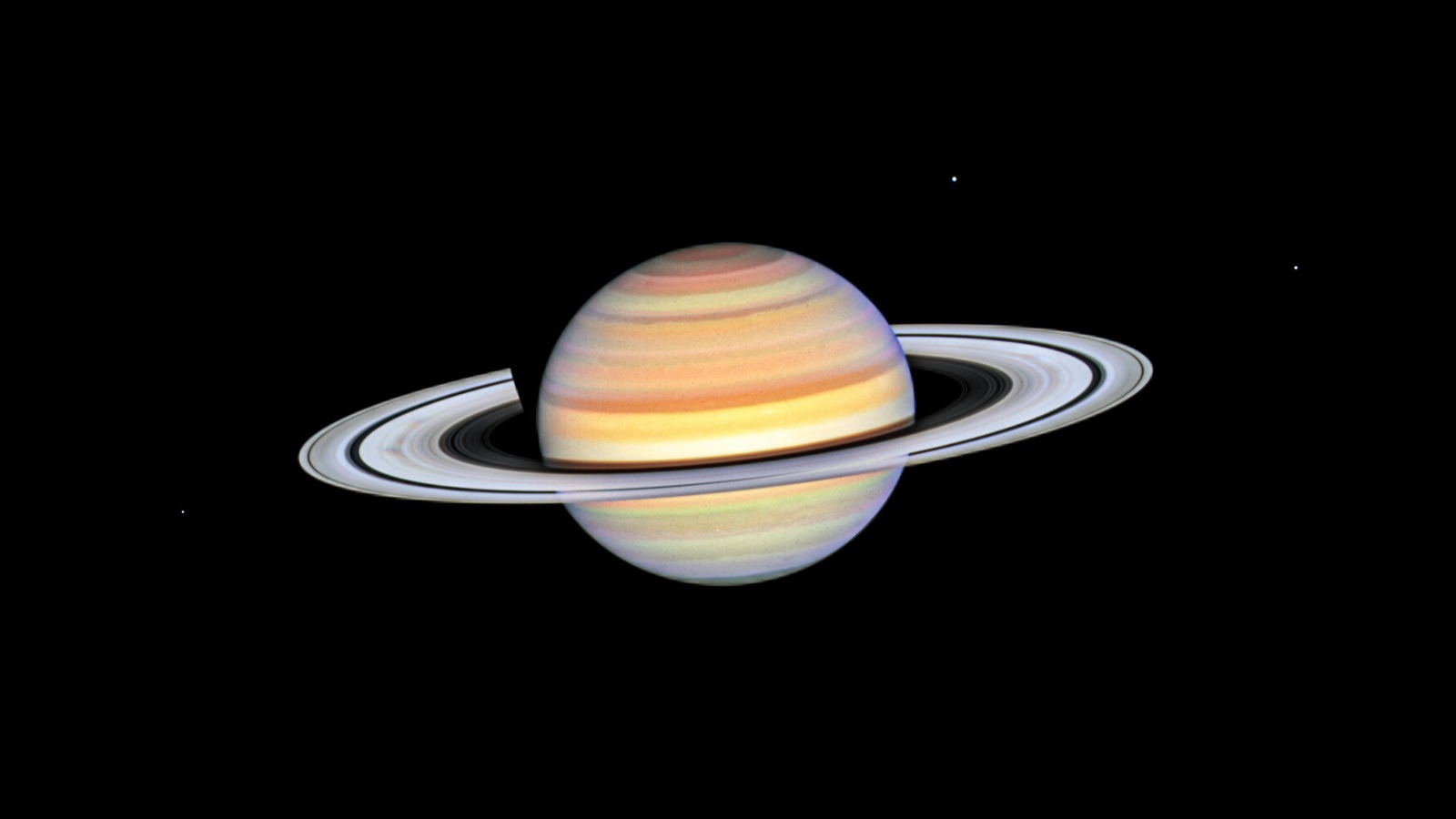 Hubble Space Telescope view of Saturn with banded atmosphere, tilted rings, and three moons — ESA/Hubble heic2312a
