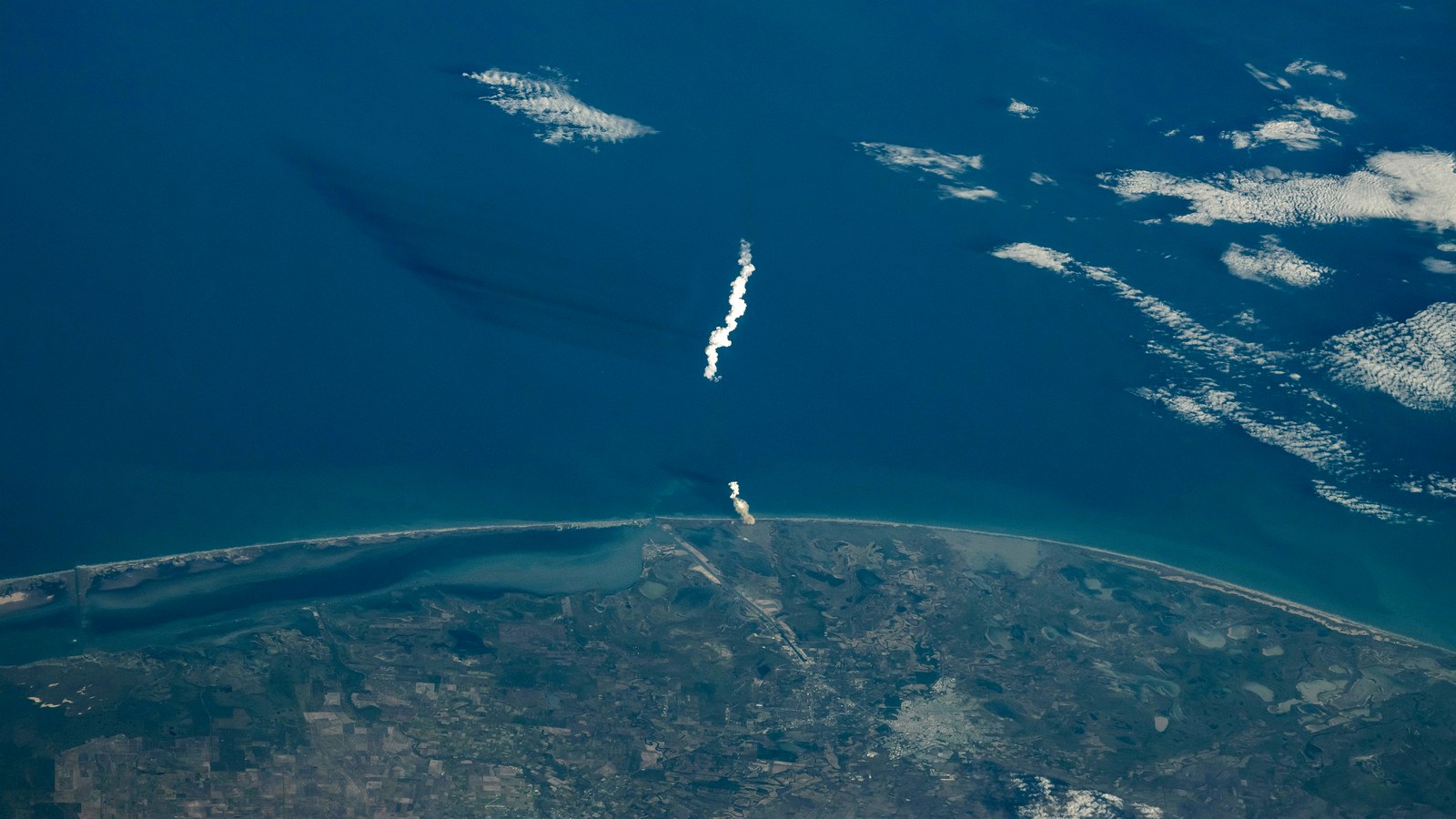 Starship launch plume over Starbase and the Gulf of Mexico, seen from the International Space Station