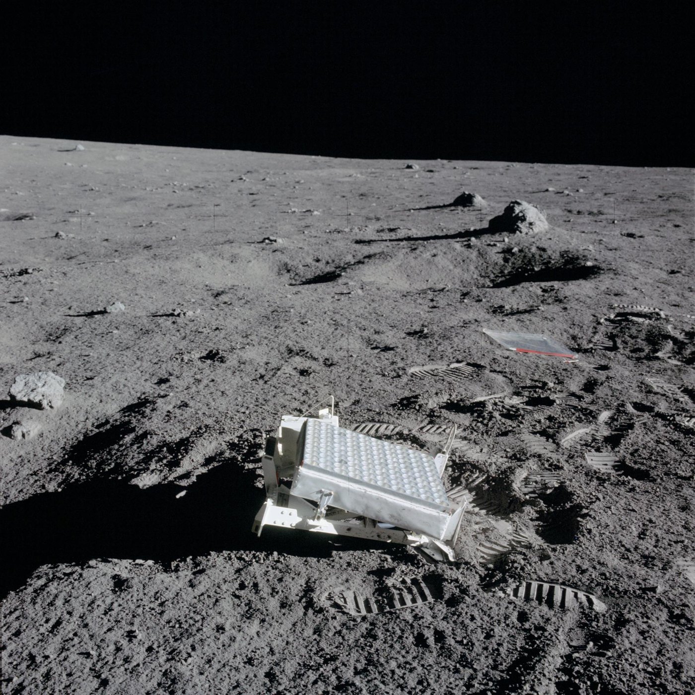 Close-up of the Apollo 14 laser ranging retroreflector, a flat panel of mirrors sitting on the gray lunar surface