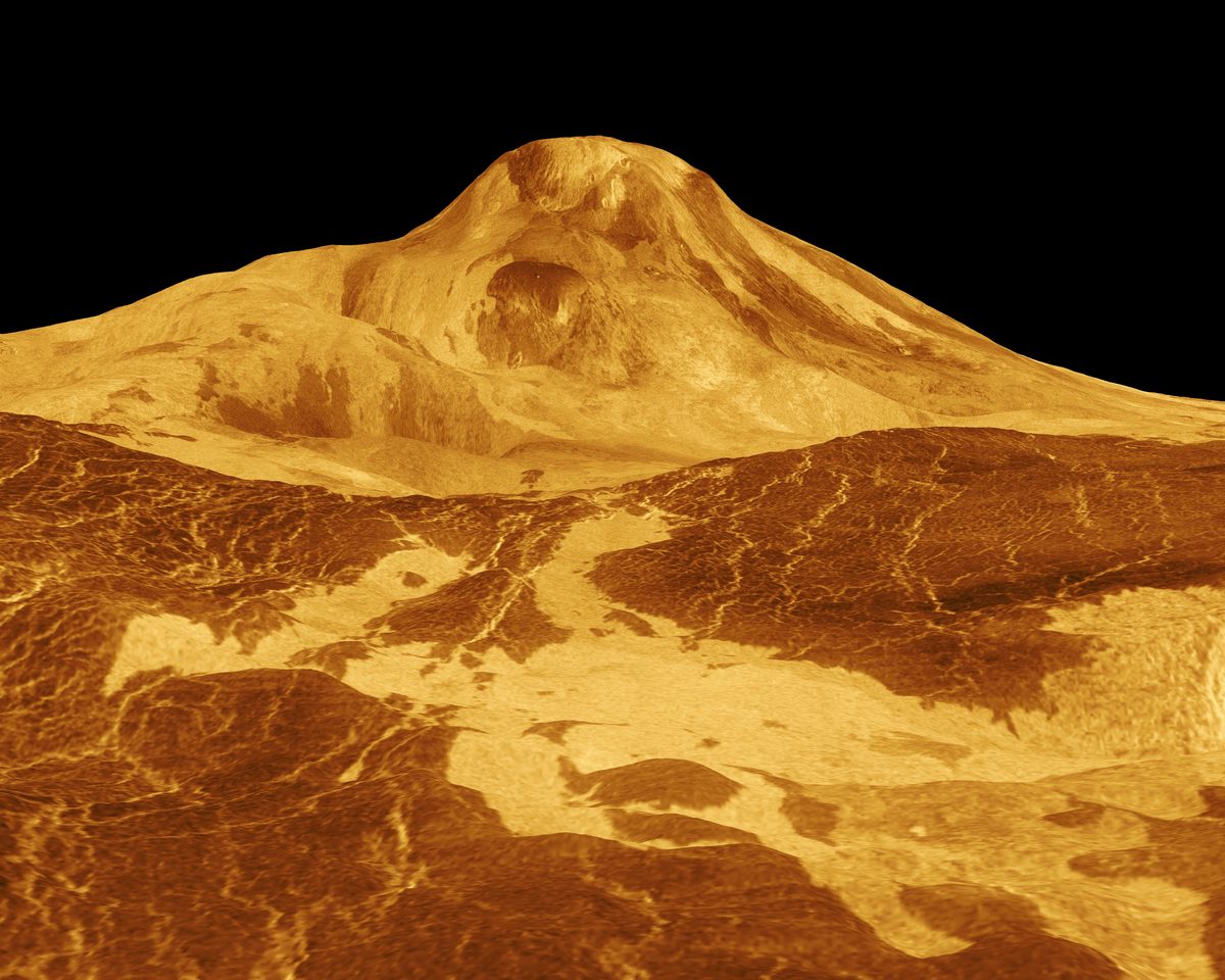 Radar-based 3D perspective view of the Venus volcano Maat Mons rising above lava flows and fractured plains, in simulated orange tones