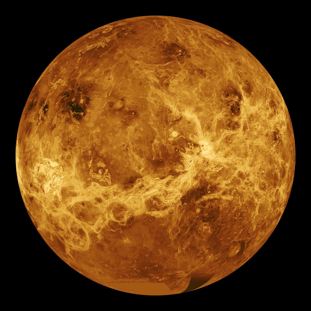 Global radar map of Venus in orange and gold tones, showing bright volcanic ridges and highlands